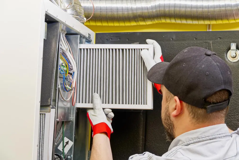 HVAC technician changing an air filter